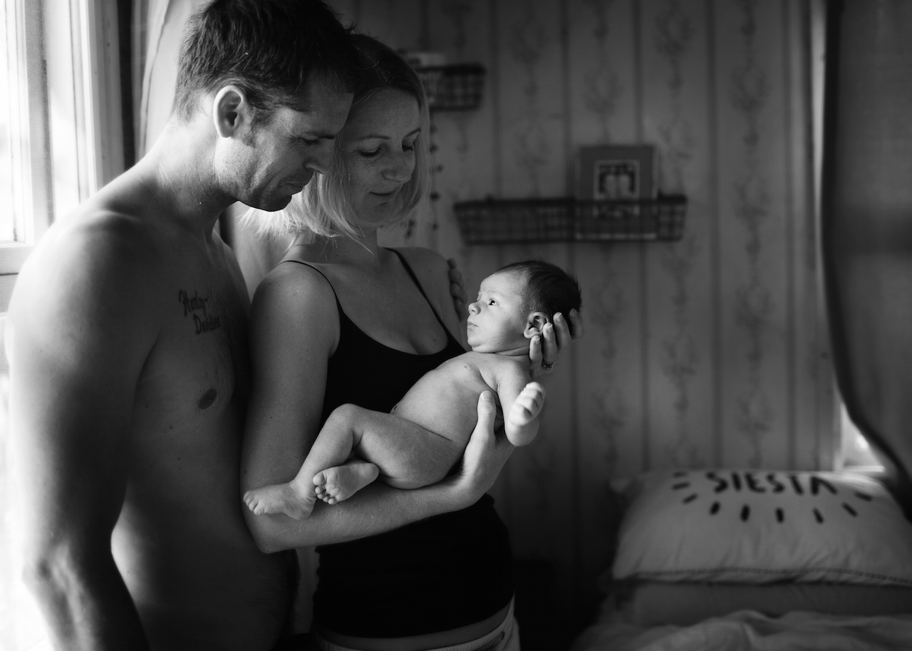 Black and white portrait of parents and baby