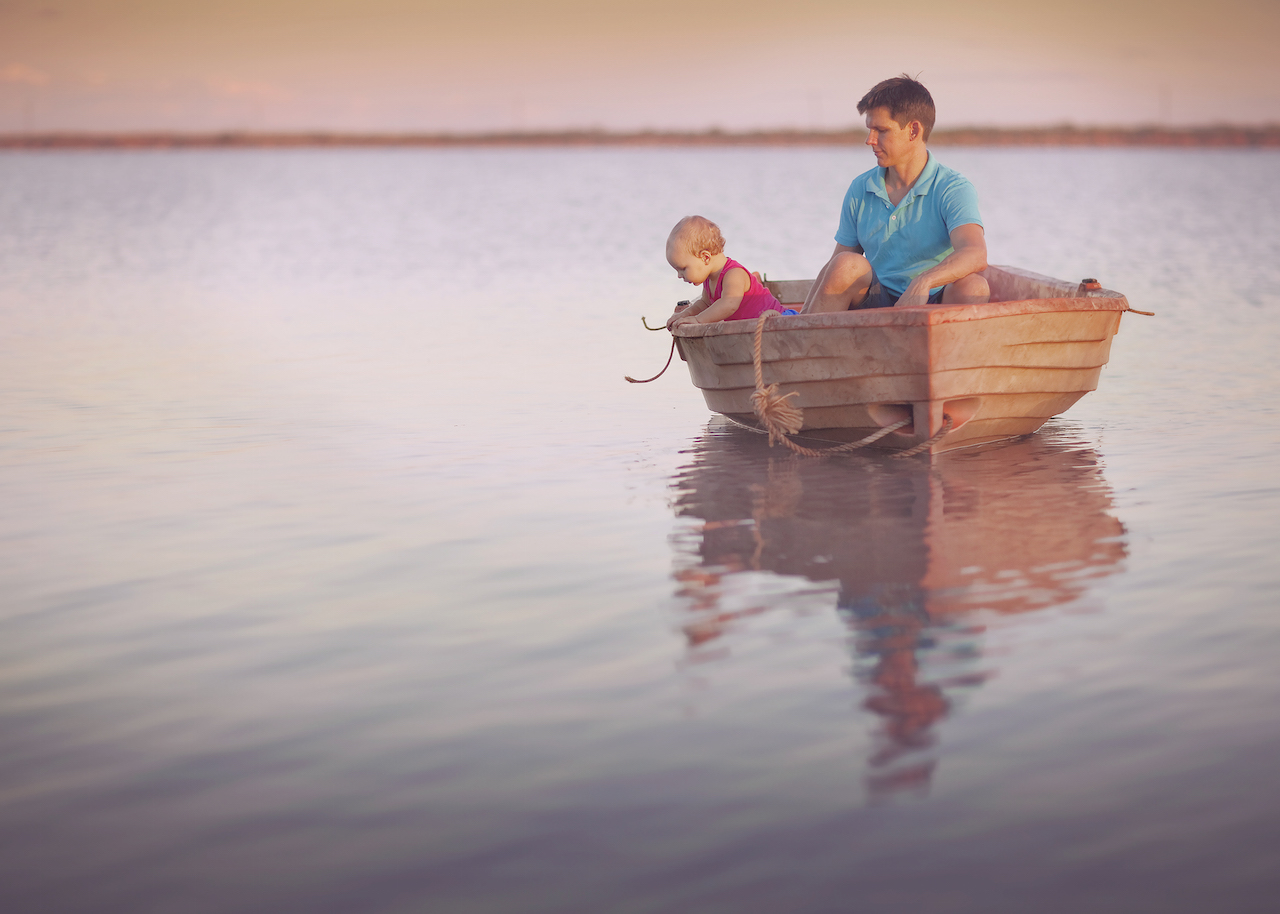 Father and baby in a small boat