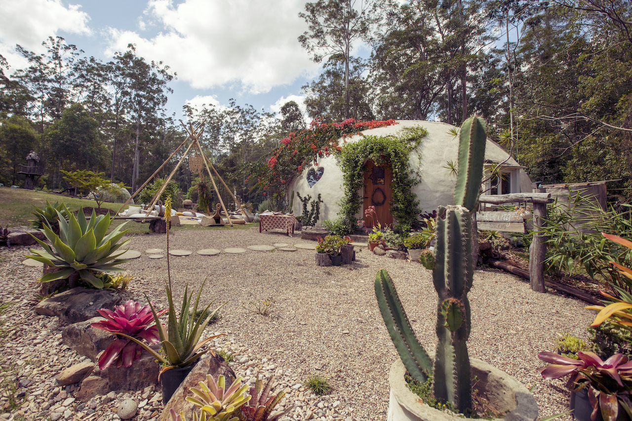 The flower-covered Wonderdome photography studio surrounded by its garden