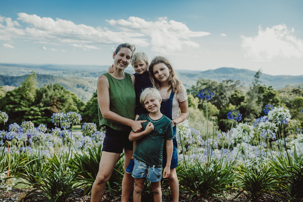 Nicole Yardley with her three children in a flowering garden at Bird Park